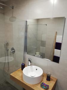 a bathroom with a white sink and a shower at Ocean Sunshine in Orzola