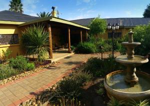a water fountain in front of a house at Aqua Terra Guest House in Lydenburg
