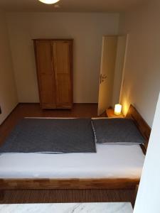a small bedroom with a bed and a cabinet at 25 Schützenstraße in Diekholzen