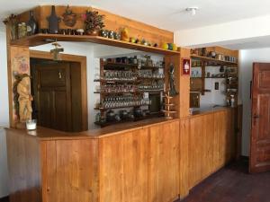 a bar with wooden cabinets and shelves in a room at Iwenica in Stara Kamienica