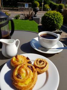 a plate of pastries on a table with a cup of coffee at 18 Craigmillar Park in Edinburgh