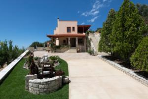 a house with a pathway leading to the front yard at Ageri Traditional Villa in Argyroupolis