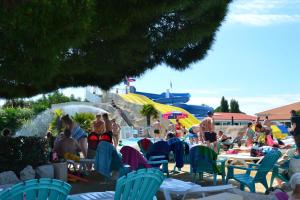 a group of people sitting in chairs at a beach at Camping les charmettes- in Les Mathes