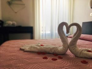 Postel nebo postele na pokoji v ubytování Hotel Graziana