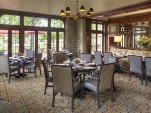 a dining room with tables and chairs and windows at Granville Inn in Granville