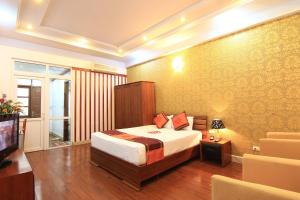 a hotel room with a bed and a television at Urban Alley Hotel in Hanoi +53 photos