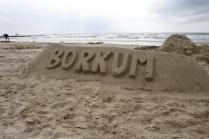 a sand sculpture on a beach with the word burrito at BORKUMUNTERKUNFT - WOH5 - IM HERZEN DER INSEL in Borkum