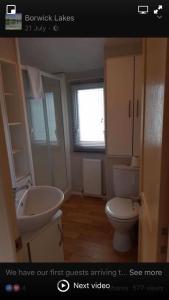 a bathroom with a sink and a toilet at Carmels Caravan Borwick Lakes in Carnforth