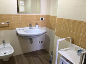 a bathroom with a sink and a toilet at 60Quattro bedrooms in Lamezia Terme