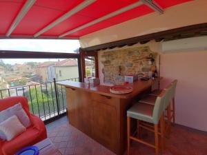a kitchen with a bar with a view of a balcony at Tangohotel in Lucca