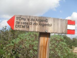 aangularangular wooden sign with writing on top of it at Appartamento Sa Funtana in Cardedu