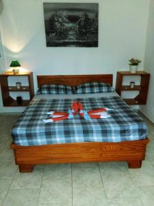 a bedroom with a bed with a blue and white plaid blanket at Casa Picadilly in Boca Chica