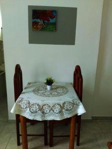 a table with two chairs and a table with a tablecloth at Casa Picadilly in Boca Chica