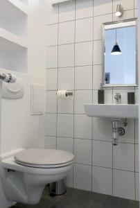 bagno bianco con servizi igienici e lavandino di Pulawska Nr 1 a Varsavia