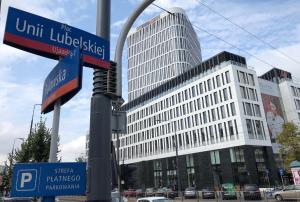 un letrero de la calle frente a un edificio alto en Pulawska Nr 1 en Varsovia