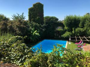 a pool in the garden of a villa at Gentil'Home - Toulouse B&B Prestige in Fenouillet