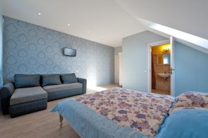 a bedroom with a bed and a couch at Karklės Villa in Karklė