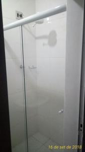 a shower with a glass door in a bathroom at Kontiki Hotel in São Francisco do Sul +26 photos