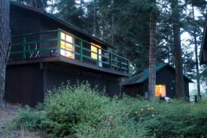 a house with a balcony with lights on it at Crater Lake Gateway-Rocky Point Resort in Klamath Falls