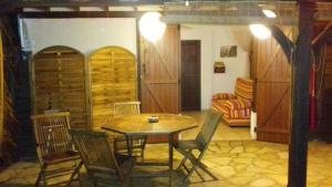 a dining room with a table and chairs and a couch at Kay Zanndoli in La Trinité