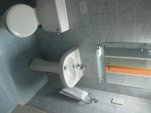 a bathroom with a toilet and a bath tub at Atrium Zenon Hotel Apartments in Larnaka