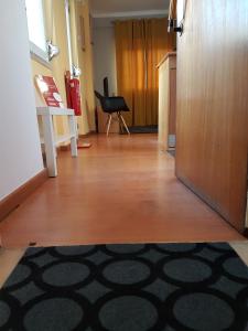 a hallway with a room with a door and a rug at Comfort City Hub - Metro Lisbon in Amadora