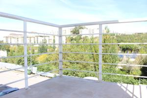 a balcony with a view of trees and buildings at Apartamento Coselhas Coimbra in Coimbra