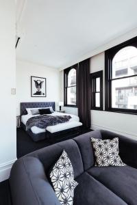 salon z kanapą i łóżkiem w obiekcie East Brunswick Hotel w Melbourne