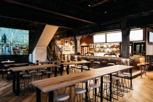 a restaurant with wooden tables and stools at East Brunswick Hotel in Melbourne