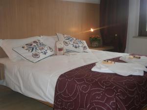 a hotel room with a bed with towels on it at Le Badie Wine Resort in Rosazzo