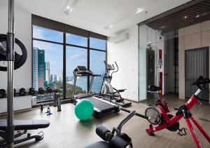 a gym with bikes and exercise equipment in a building at Sochi Hotel in Nha Trang