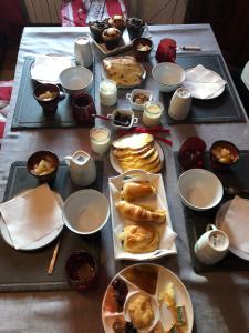 a table with plates of food and candles on it at Les chambres de cathy in Labastide-Murat +23 photos