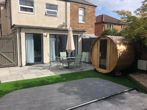 a garden with a large wooden tree house at Bournemouth Hot Tub & Sauna Holiday Let in Bournemouth