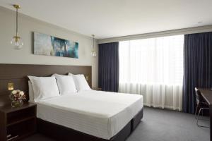 Un pat sau paturi într-o cameră la Bayview Eden Melbourne