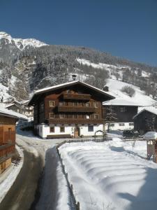 a large building in the snow with a snow covered road at Tofererhof in Bad Hofgastein