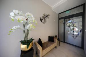a lobby with a chair and a vase of flowers at Teatro Verdi Boutique Hotel in Zadar
