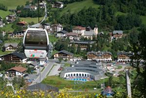 a gondola flying over a town with a stadium at Hotel Kirchenwirt in Bad Kleinkirchheim