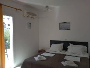 a bedroom with two beds with towels on them at Hiona Apartments in Elounda