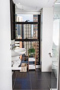 a bathroom with a sink and a window at Executive stay Little Collins street in Melbourne