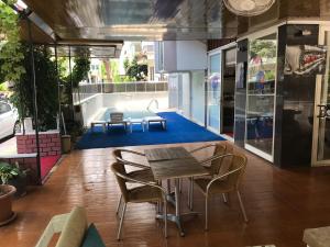 a dining area with a table and chairs in a building at Sempati Apart Hotel in Alanya