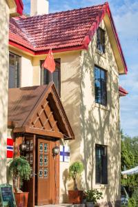 a house with a wooden door and a red flag at Nordic Memory in Qingdao in Qingdao