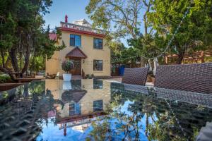 a house with a reflection in the water of a pool at Nordic Memory in Qingdao in Qingdao
