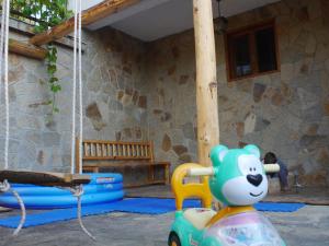 a toy bear on a toy car in a playground at Family Hotel Silver in Smolyan