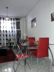 a dining room with red chairs and a table at Αnna's Home!!!Holidays in beautiful Athens in Athens