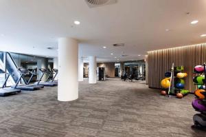 a gym with a bunch of exercise equipment in a building at Melbourne Private Apartments - Collins Street Waterfront, Docklands in Melbourne