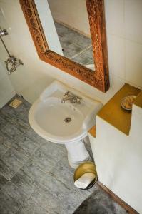 a white sink in a bathroom with a mirror at Zanzibar Coffee House in Zanzibar City
