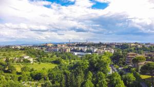 an aerial view of a city with trees and buildings at Glamping Siena in Siena +51 photos