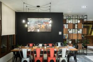 a dining room with a table and red chairs at Timber House in Kathmandu