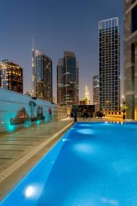 a large swimming pool in front of a large building at Grand Millennium Business Bay in Dubai