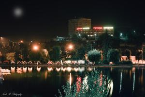 a view of a city at night with a lake at Kirovakan Hotel in Vanadzor
